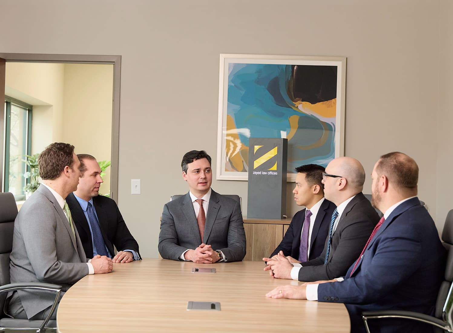 Zayed Law attorneys meeting in the firm’s conference room